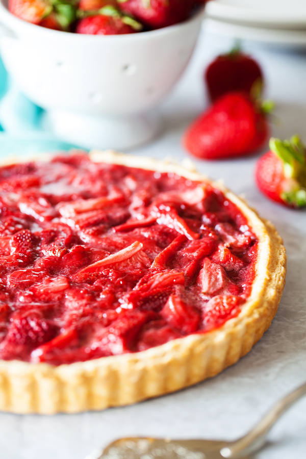 Bursting with strawberry flavor, this Strawberry Tart is loaded with fresh strawberries floating atop a melt-in-your-mouth pate sucrée crust.