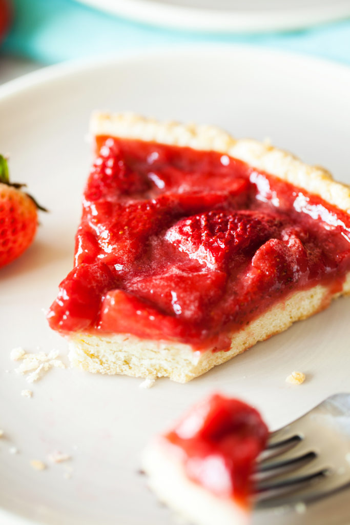 Bursting with strawberry flavor, this Strawberry Tart is loaded with fresh strawberries floating atop a melt-in-your-mouth pate sucrée crust.