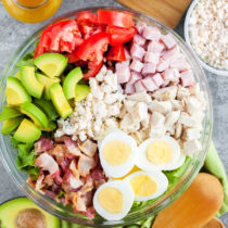 A Classic Cobb Salad loaded with fresh vegetables, three kinds of meat, hard boiled eggs, and blue cheese crumbles.
