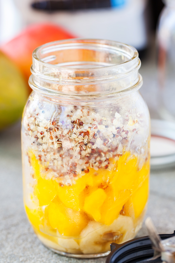 Mason jar of bananas, mangoes, and cooked quinoa. 