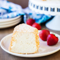 Light and airy Angel Food Cake, delicious with powdered sugar, strawberries or whipped cream!