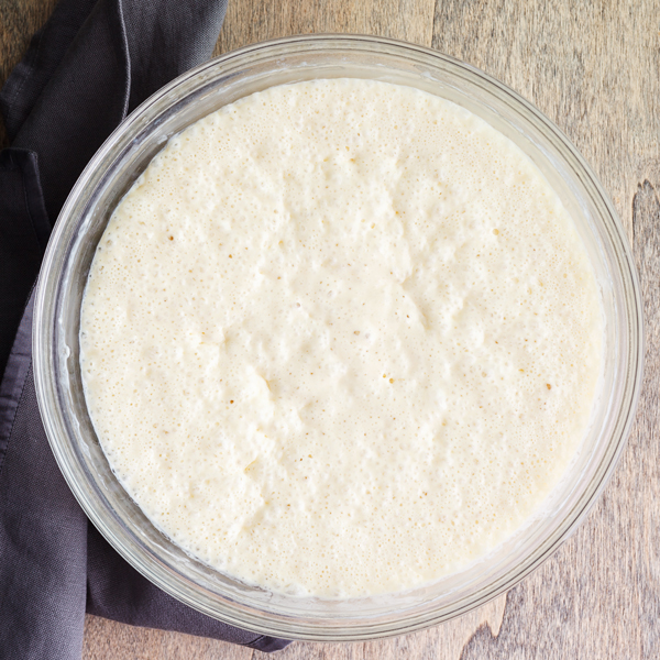 Birds-eye view of yeast waffles batter in bowl. 