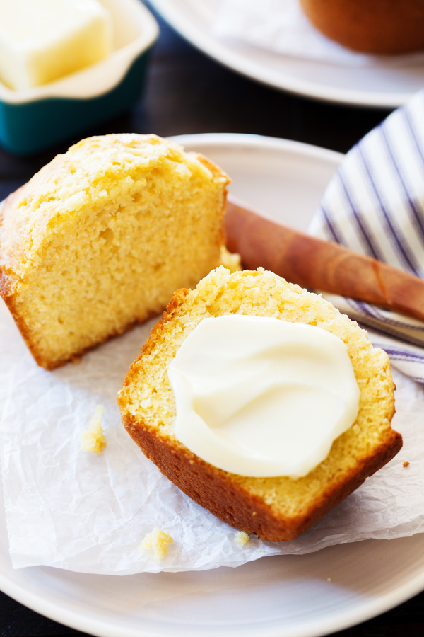 Cut cornbread muffin with a pat of butter.