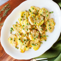 Pops of color, aromatic herbs, and nutty flavors will make these smashed pea-tatoes a beautiful addition to any holiday table.