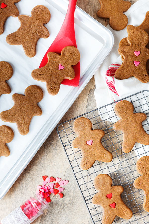 Birds-eye view of baked gingerbread cookies on a sheet pan and cooling rack. 