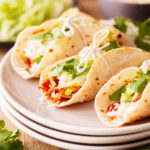 Shredded chicken and fajita vegetables in a smoky and spicy red sauce will make Chicken Ropa Vieja your new favorite taco filling or salad protein.