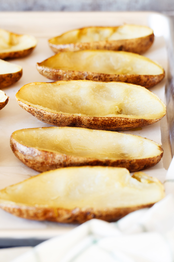 Empty potato skins on a baking sheet. 