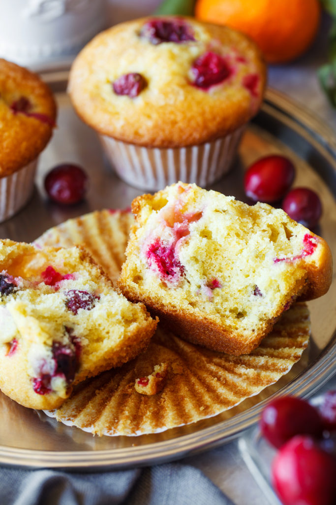 Split open tangerine cranberry muffin on an opened liner.