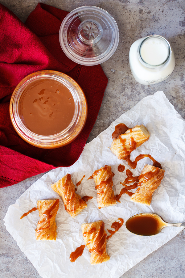 Churros drizzled with dulce de leche and paired with milk.