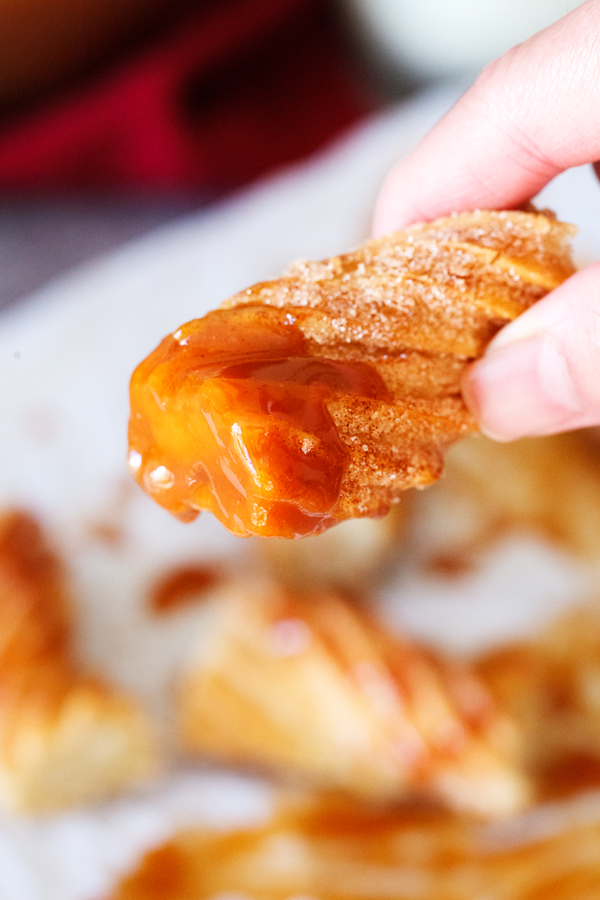 Churro partially dipped in dulce de leche. 