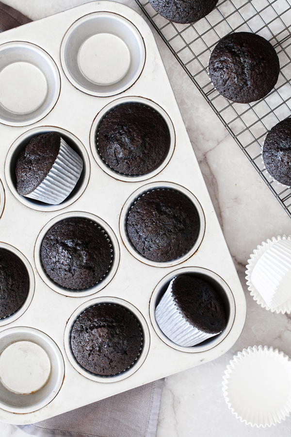 Birds-eye view of chocolate cupcakes in baking pan. 