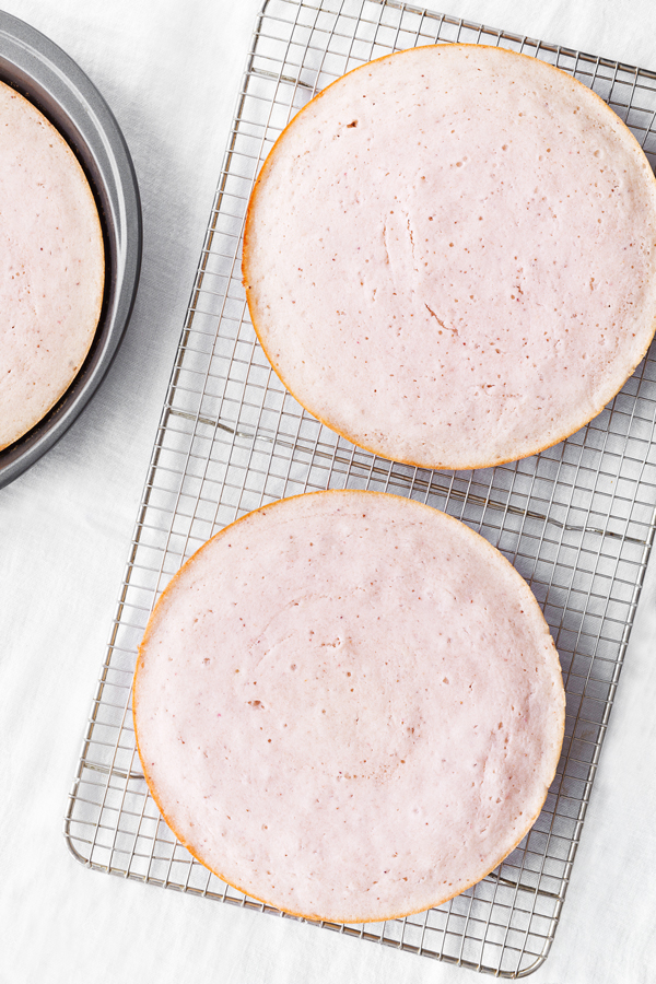 Baked strawberry cake on a cooling rack.