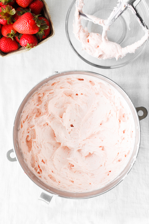 Fresh strawberry frosting in a stand mixer bowl.