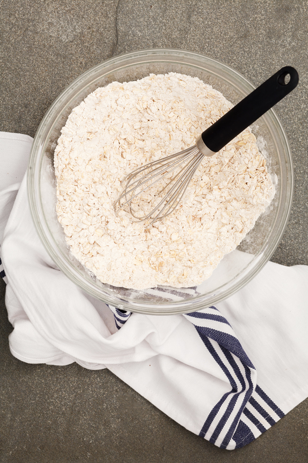 Preparation step for thick and chewy oatmeal raisin cookies - mixing of dry ingredients.