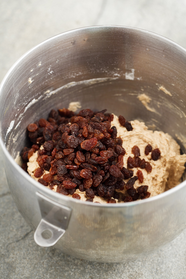 Preparation step for thick and chewy oatmeal raisin cookies - addition of raisins.