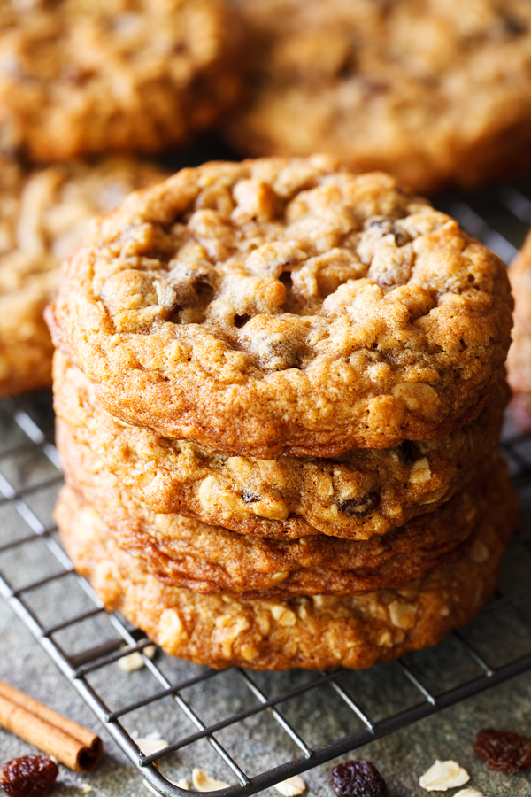 Stack of thick and chewy oatmeal raisin cookies on a cooling rack.
