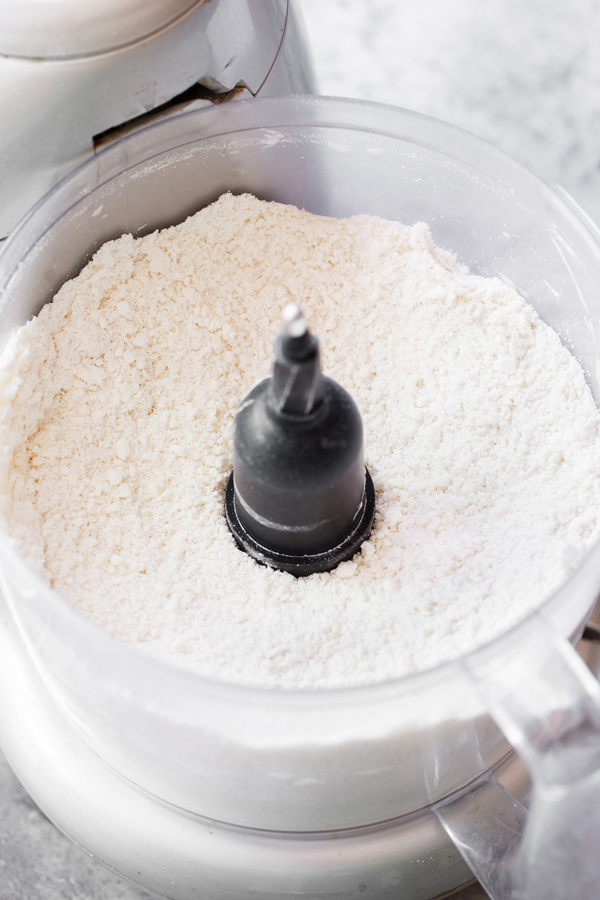 Preparation step for plum crostata - crostata crust ingredients in food processor.