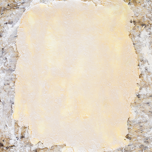 Preparation step for flakey all-butter pie crust - slab of rolled pie dough