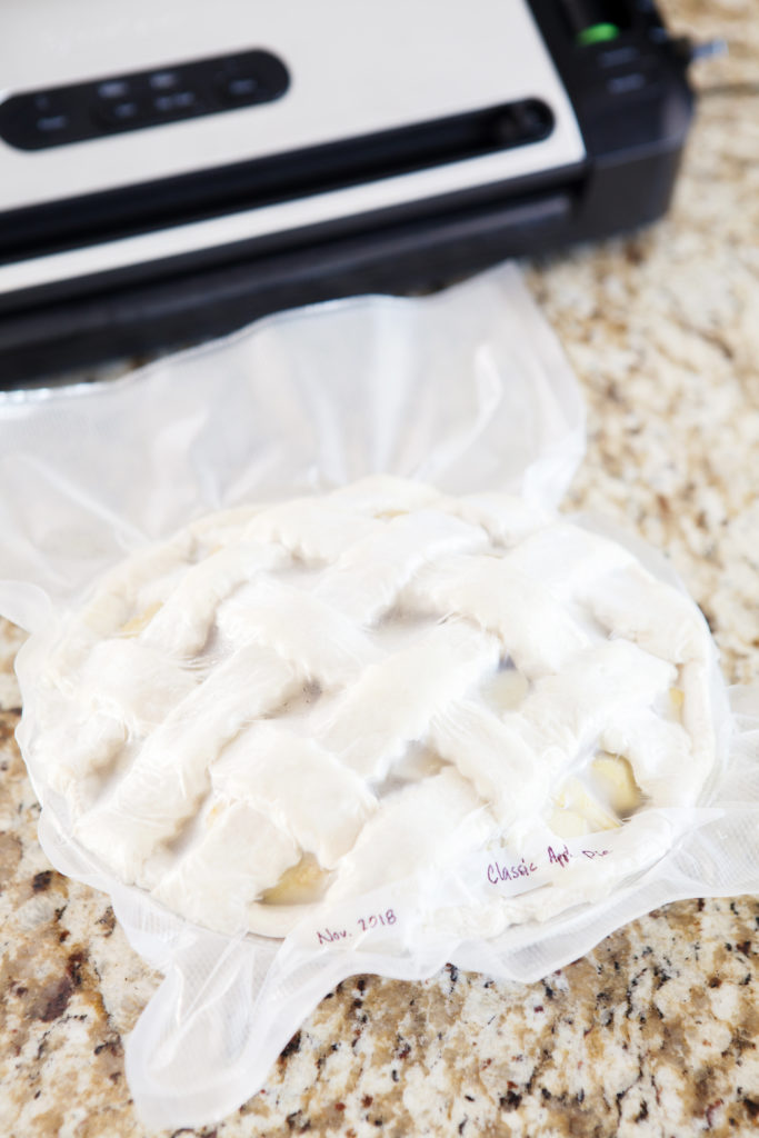 Unbaked classic apple pie being vacuum sealed with FoodSaver