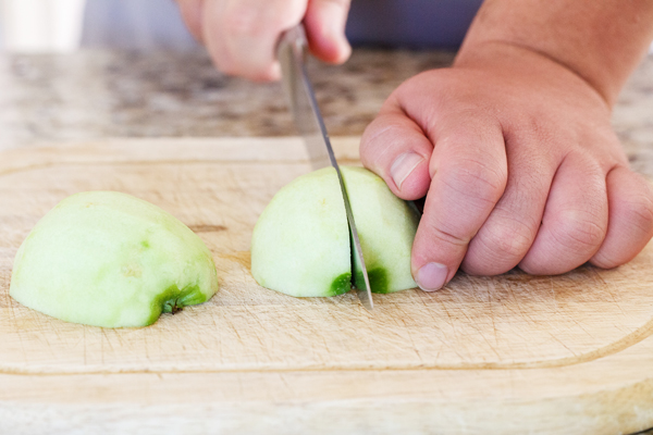 Half apple being quartered.