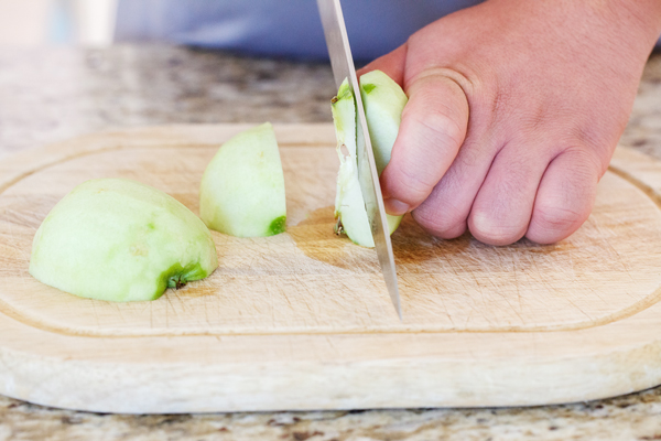 Peeled apple being cored.