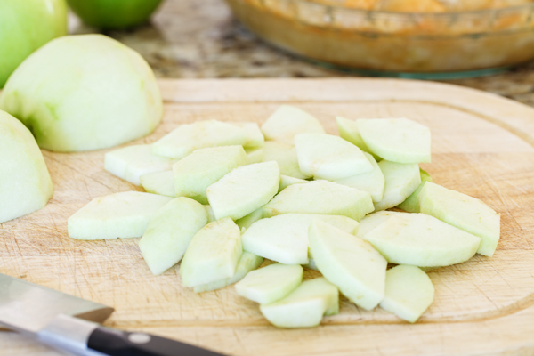 Sliced apples on cutting board.