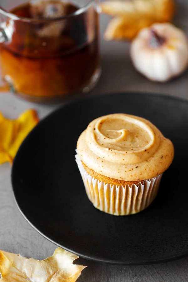 Pumpkin spice latte cupcake on plate.