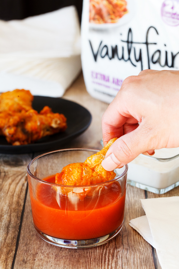 Baked buffalo wing dipped in buffalo sauce