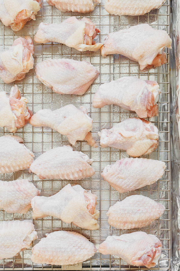 Preparation step for baked buffalo wings - wings on baking rack.