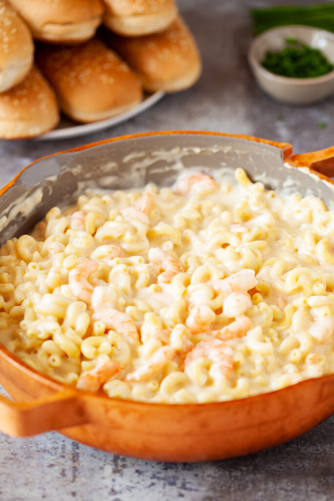 Shrimp macaroni and cheese in a skillet, fresh off the stove.